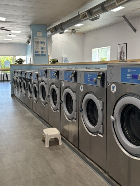 A row of Electrolux washers inside Scrubs Laundry